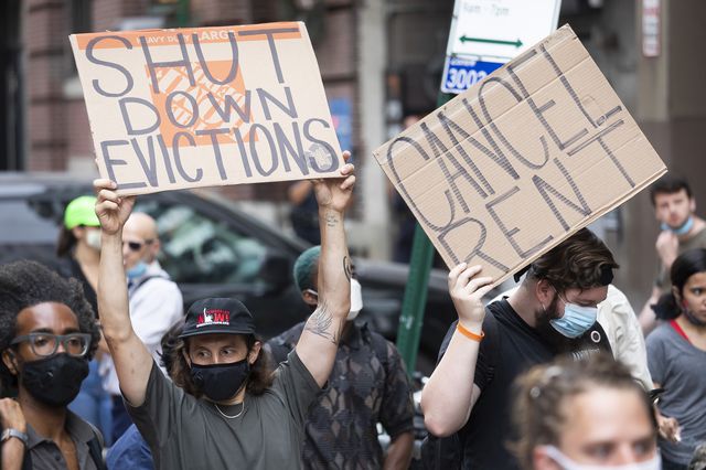 Tenant activists protesting outside of Brooklyn housing court August 6th, 2020 with "shut down eviction" and "cancel rent" signs.
